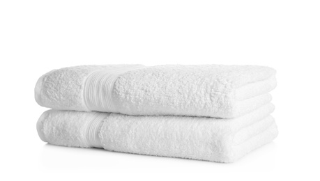 Photo of Stack of clean soft towels on white background