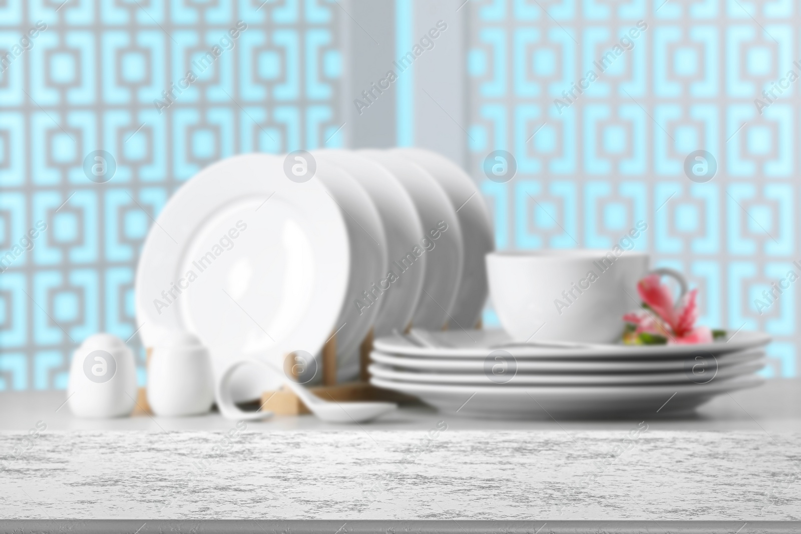 Image of Set of clean dishware, focus on empty stone table