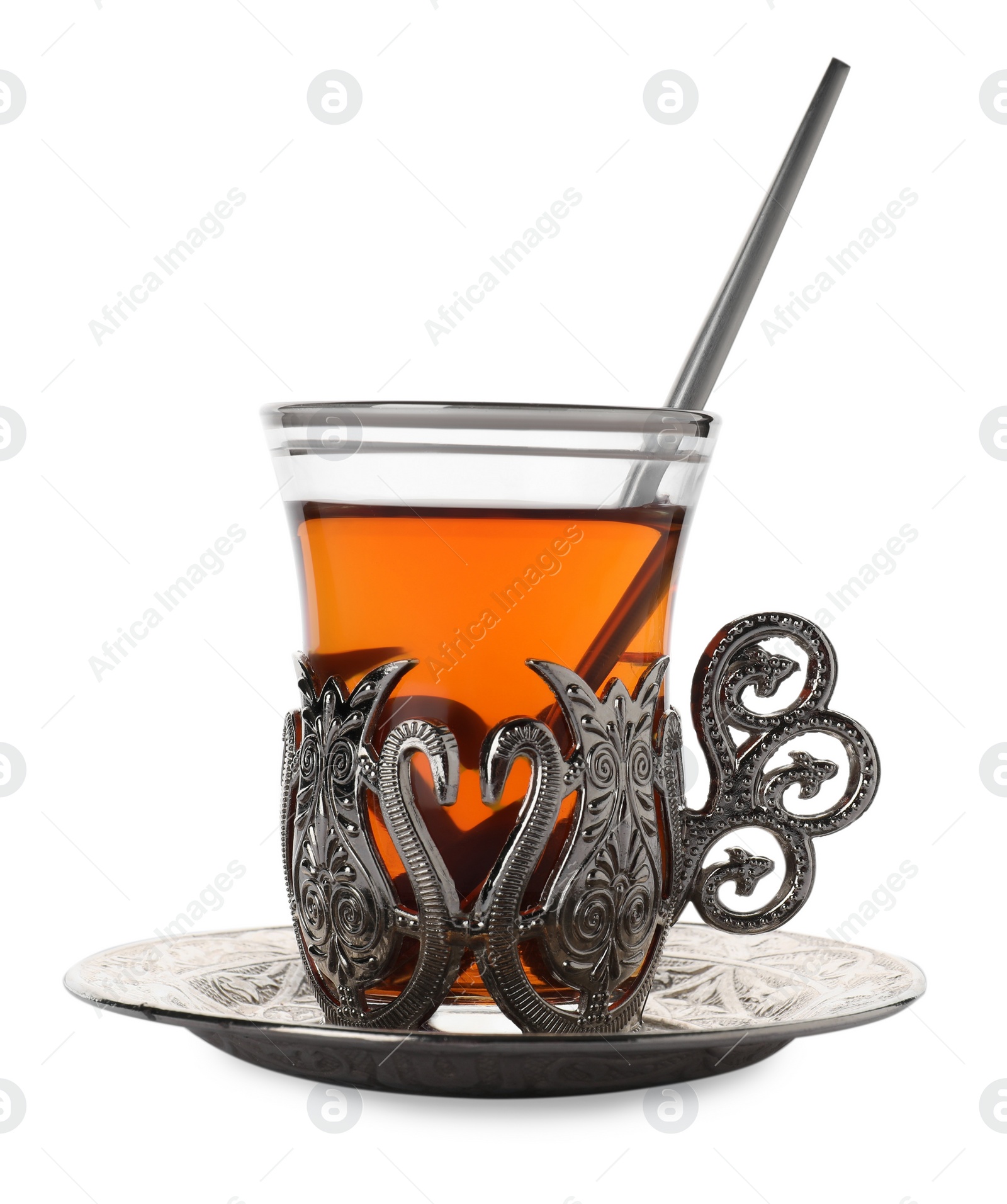 Photo of Glass of traditional Turkish tea in vintage holder isolated on white