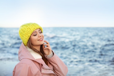 Portrait of beautiful young woman near sea