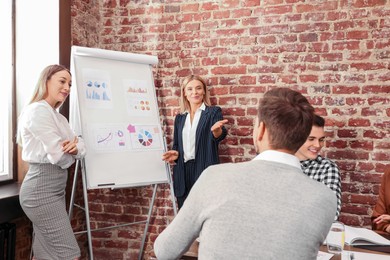 Businesswoman having meeting with her employees in office. Lady boss