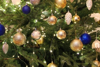 Beautifully decorated Christmas tree with different baubles, closeup