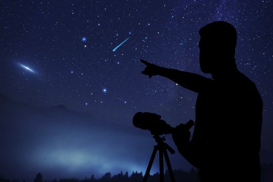 Astronomer with telescope pointing at shooting star outdoors