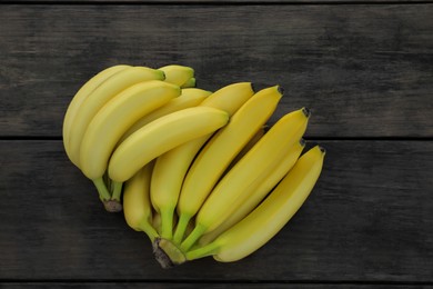 Photo of Ripe yellow bananas on wooden table, flat lay