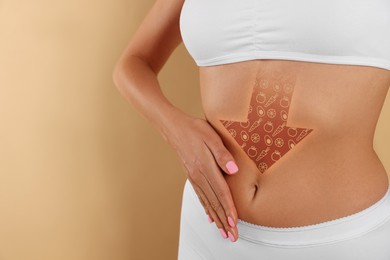 Image of Healthy digestion. Woman touching her belly against beige background, closeup. Down arrow with illustration of different products inside