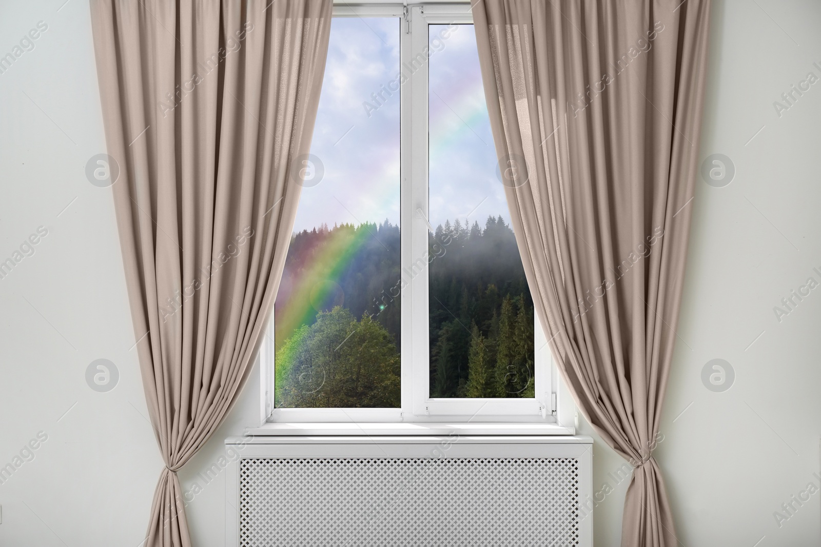 Image of View of beautiful bright rainbow through window