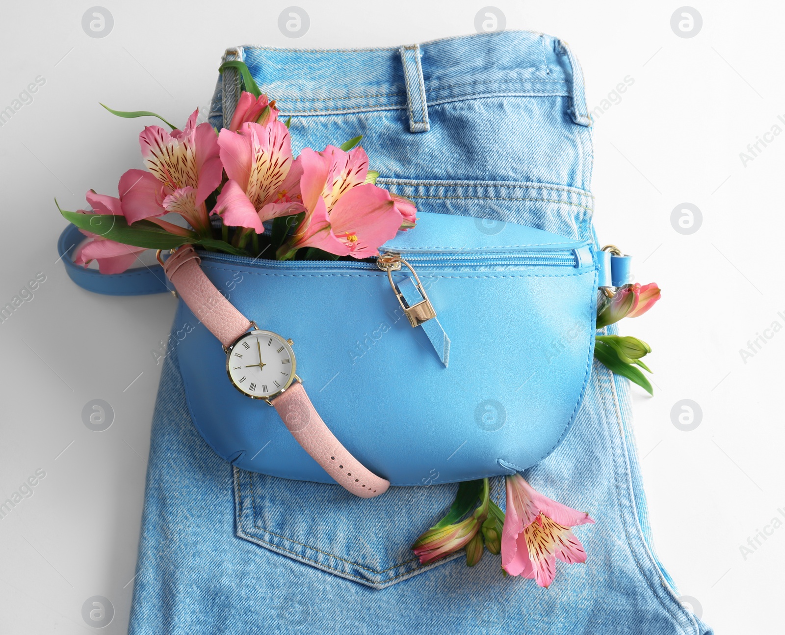 Photo of Flat lay composition with stylish bump bag and spring flowers on light background