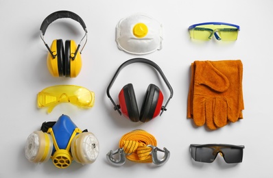 Flat lay composition with safety equipment on white background