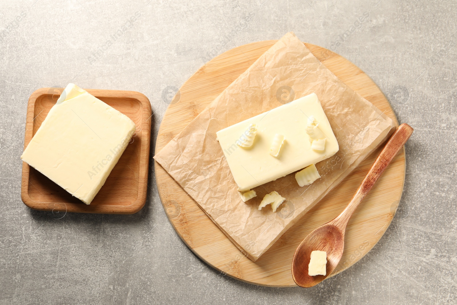 Photo of Tasty butter on grey table, top view