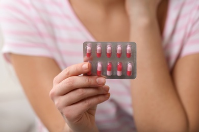 Photo of Young woman with pills, closeup of hand