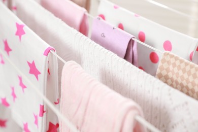 Photo of Different apparel drying on clothes airer, closeup