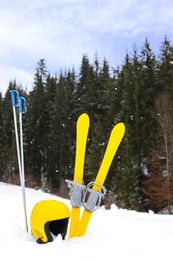Photo of Ski equipment in snow outdoors. Winter vacation