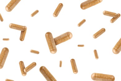 Image of Vitamin. Many capsules falling on white background