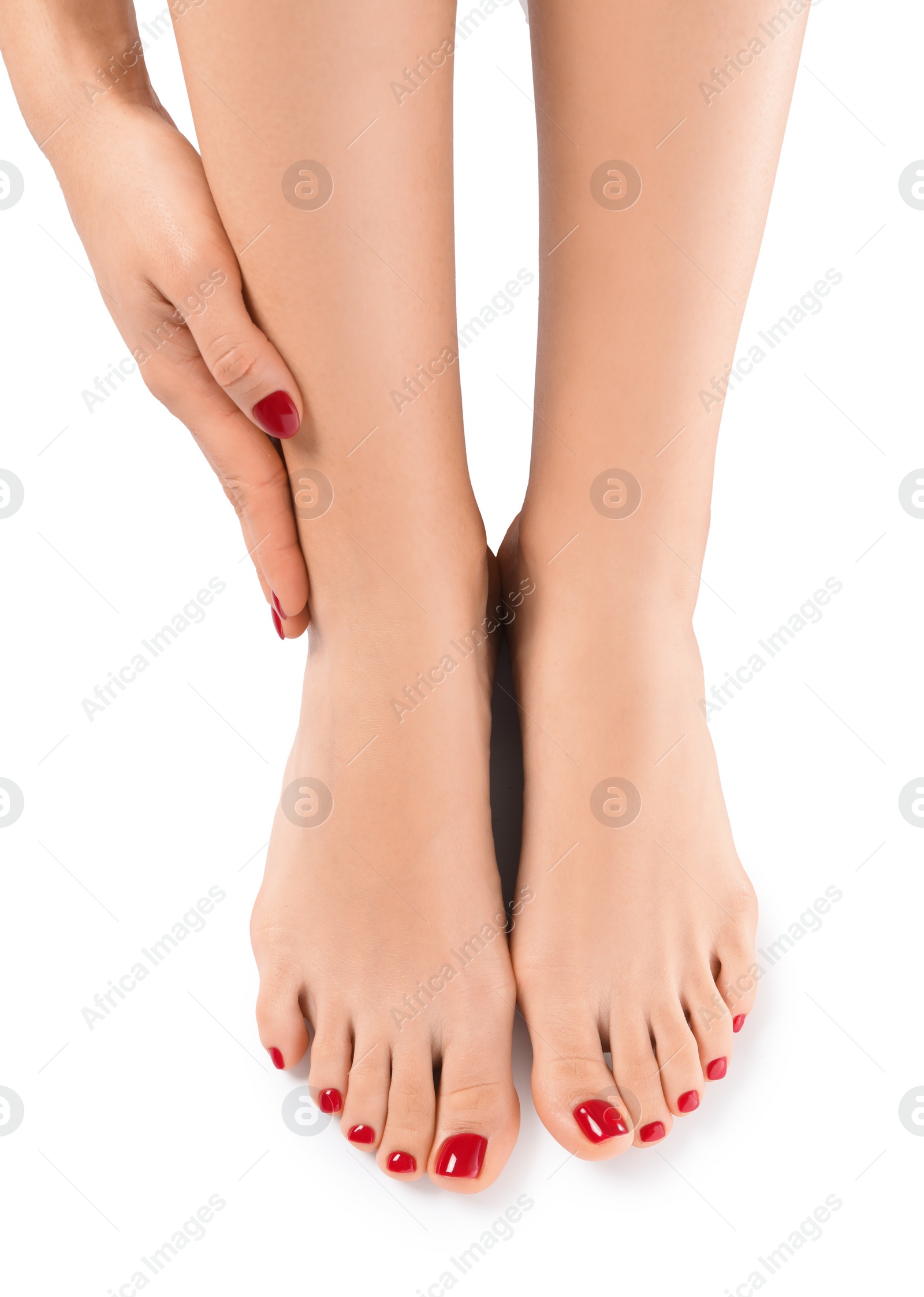 Photo of Woman with stylish red toenails after pedicure procedure isolated on white, top view