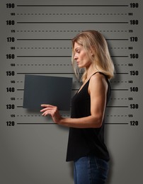 Image of Criminal mugshot. Arrested woman with blank card against height chart