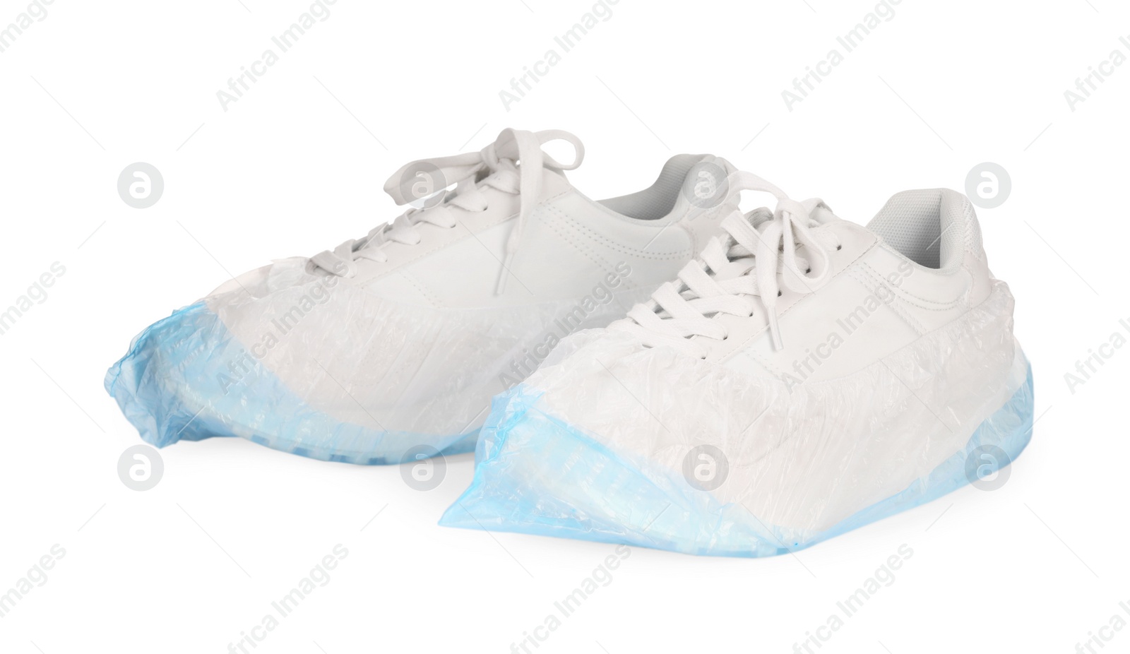 Photo of Sneakers in shoe covers isolated on white