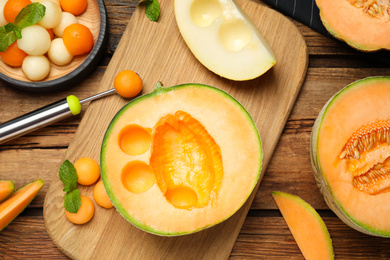 Photo of Flat lay composition with melon balls on wooden table