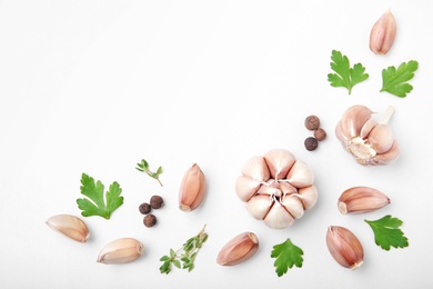 Flat lay composition with garlic on light background