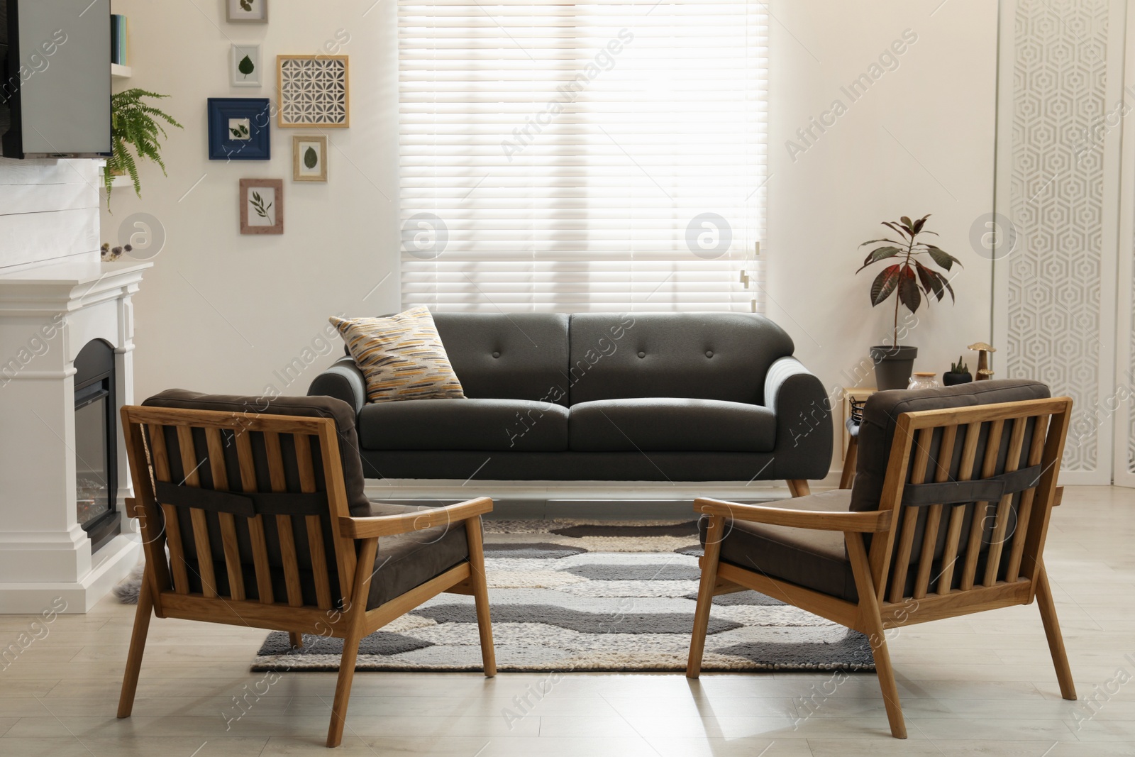 Photo of Cozy living room interior with comfortable sofa, armchairs and decorative fireplace