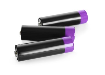 Image of Many new AA batteries on white background