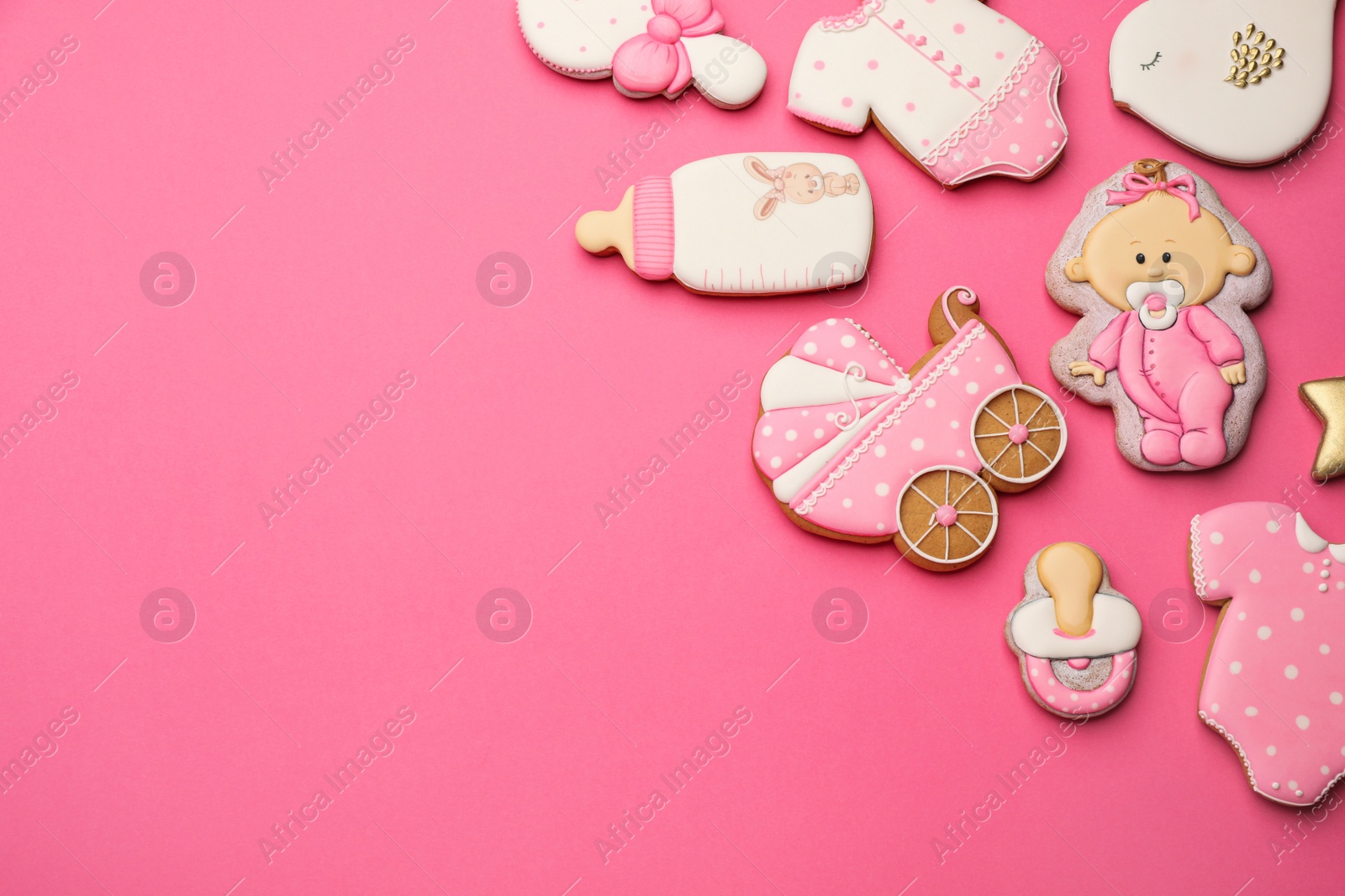 Photo of Cute tasty cookies of different shapes on pink background, flat lay with space for text. Baby shower party