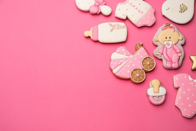 Cute tasty cookies of different shapes on pink background, flat lay with space for text. Baby shower party