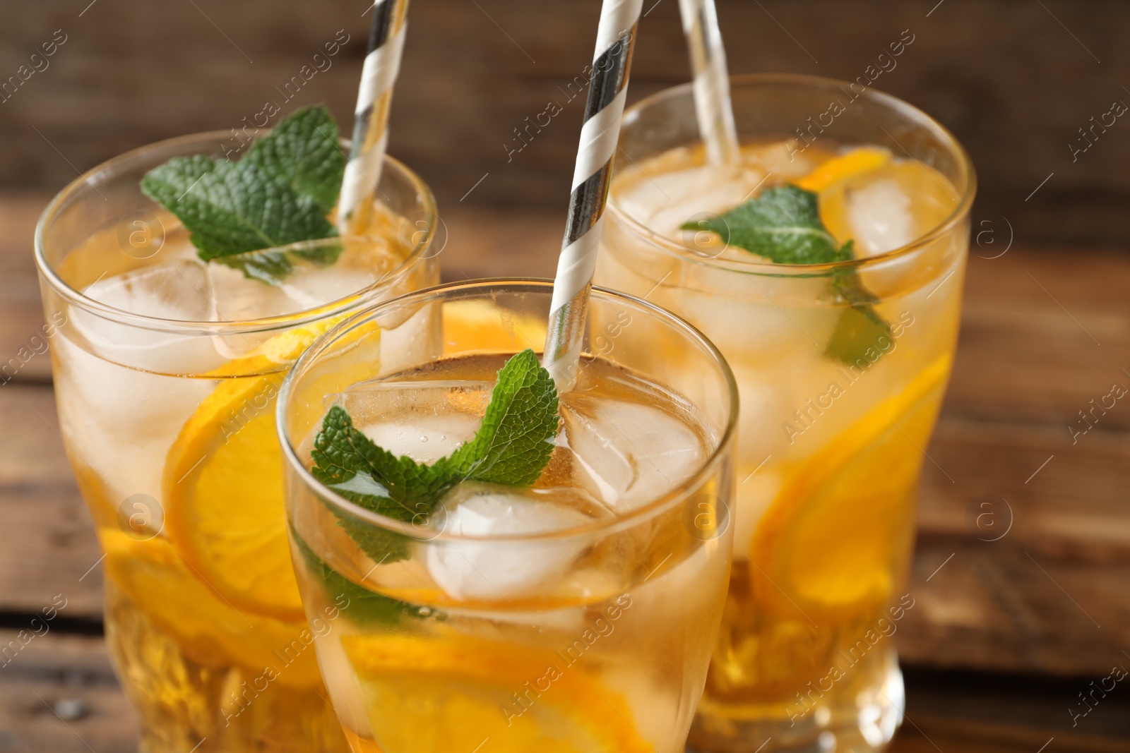 Photo of Delicious refreshing drink with orange slices on table, closeup