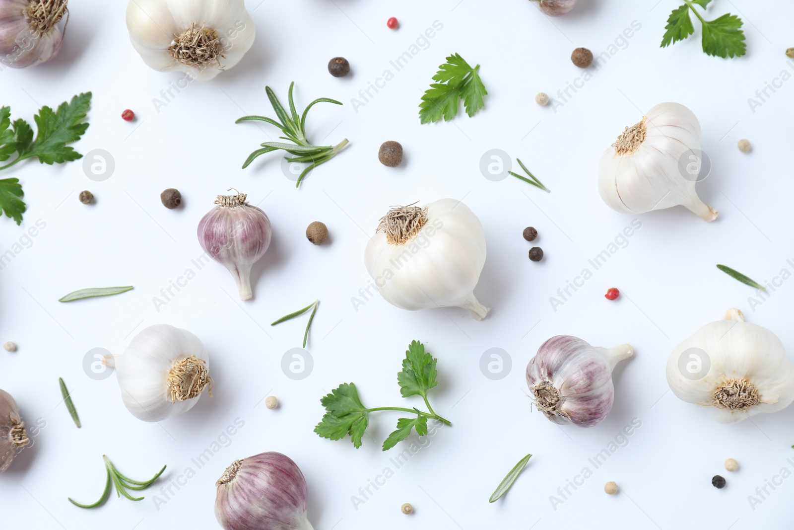 Photo of Fresh raw garlic heads and spices on white table, flat lay