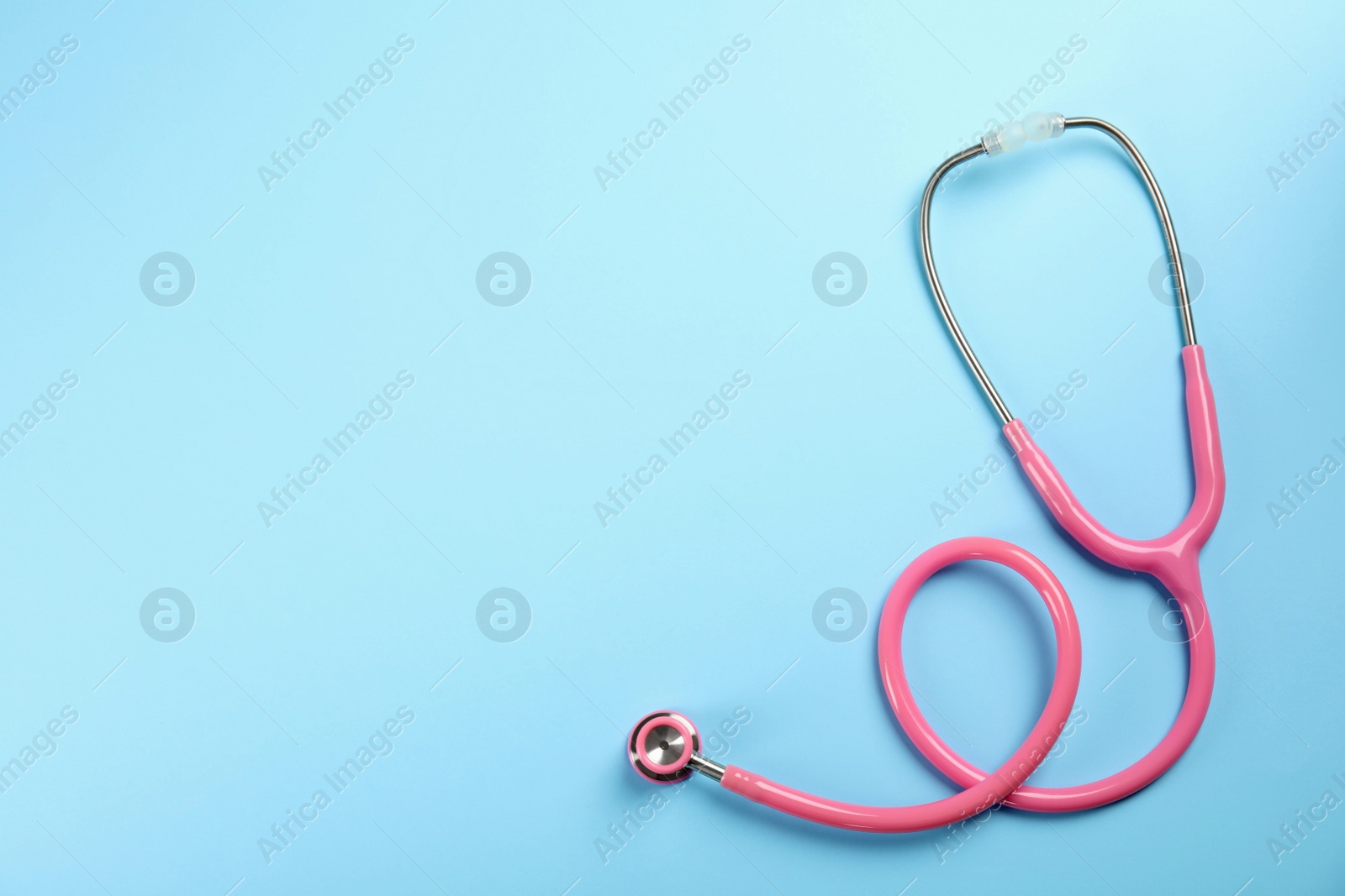 Photo of Stethoscope with space for text on color background, top view. Medical tool