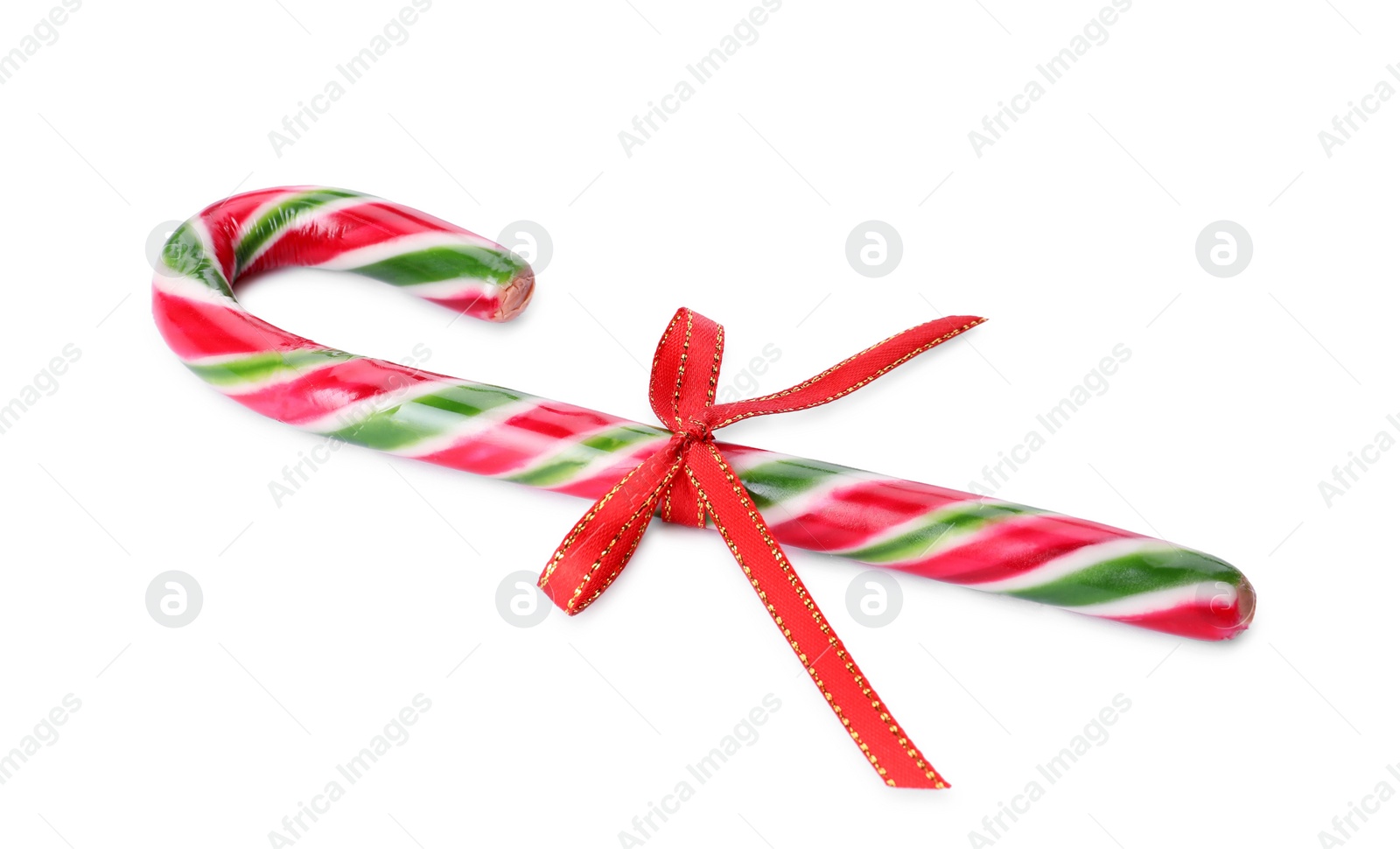 Photo of Sweet Christmas candy cane with red bow on white background