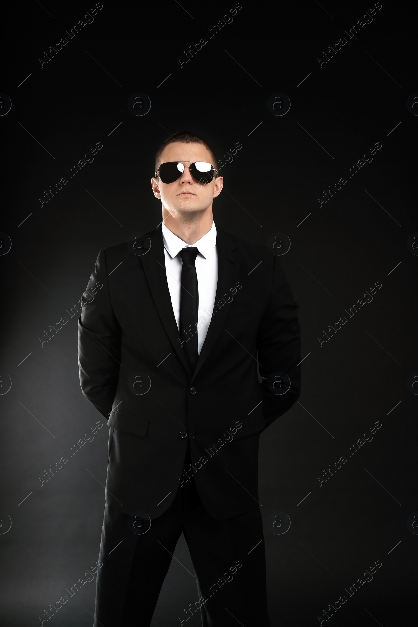 Photo of Male security guard in uniform on dark background