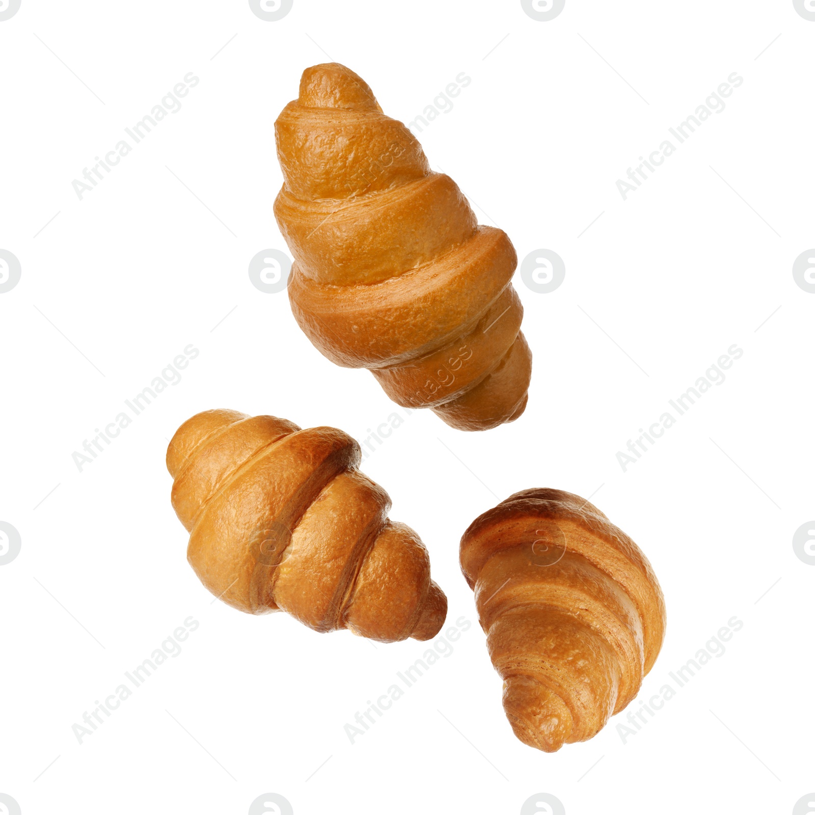 Image of Crusty golden croissants falling on white background