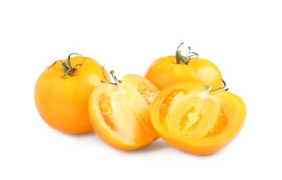 Photo of Cut and whole yellow tomatoes on white background