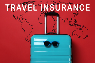 Blue suitcase with sunglasses and phrase TRAVEL INSURANCE on red background