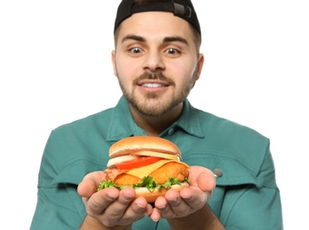 Photo of Handsome man with tasty burger isolated on white