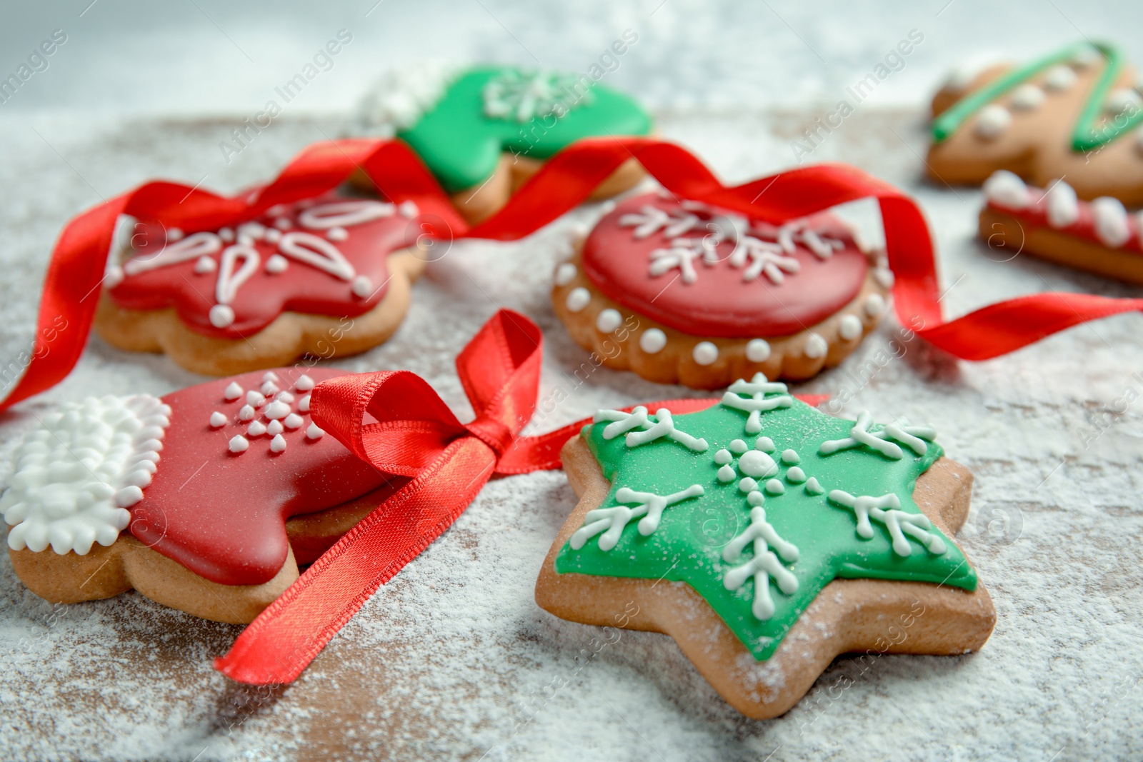 Photo of Tasty decorated Christmas cookies on wooden board, closeup