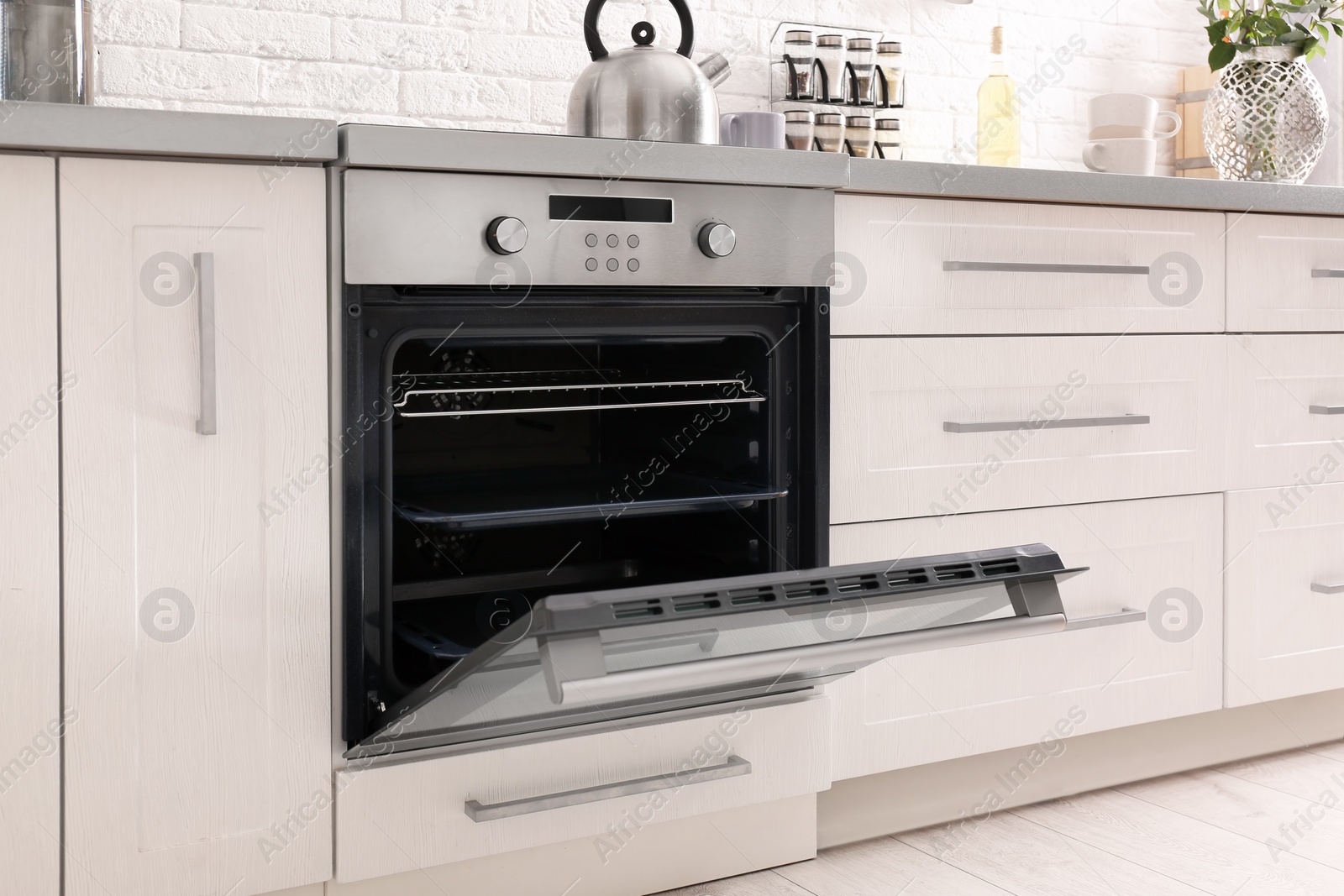 Photo of Open modern oven built in kitchen furniture