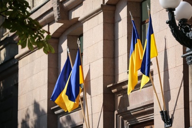 National flags of Ukraine on building wall outdoors