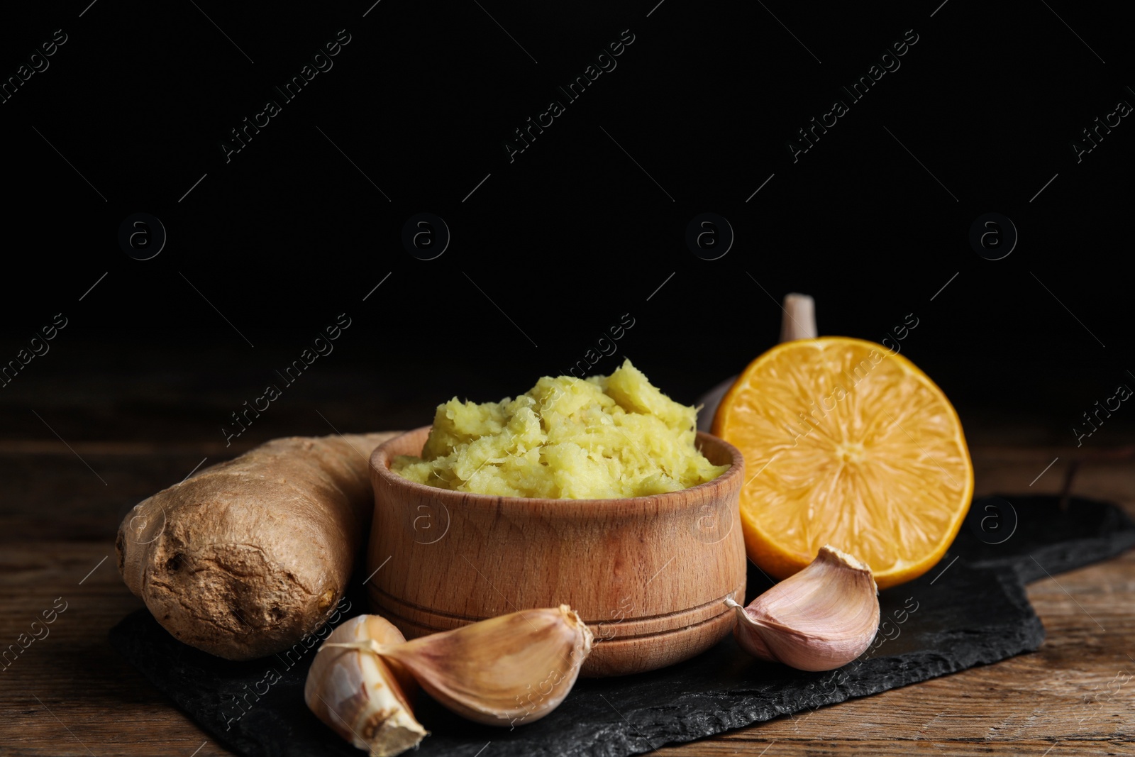 Photo of Fresh garlic and other natural cold remedies on wooden table