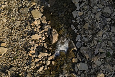 Aerial view of rocky terrain with creek. Drone photography