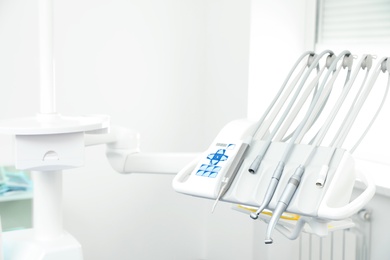 Photo of Set of professional equipment in dentist's office. Space for text