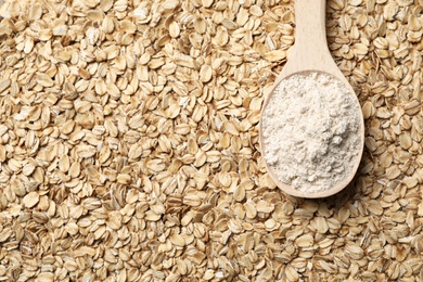 Spoon of gluten free flour on oatmeal, top view with space for text