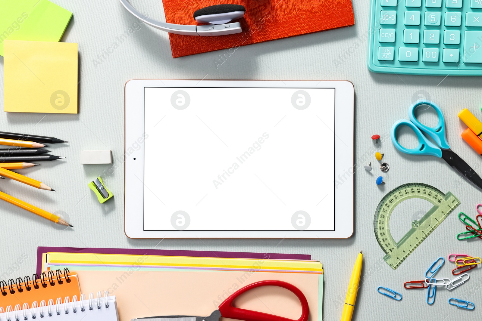Photo of Modern tablet and stationery on grey background, flat lay. Space for text