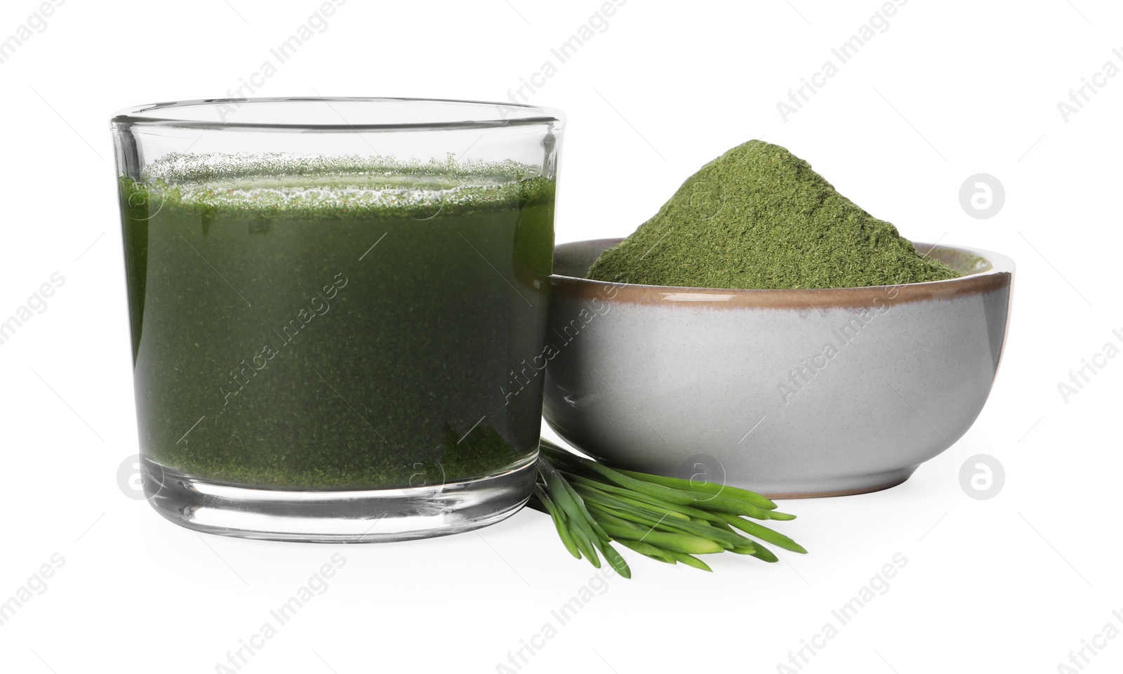 Photo of Wheat grass drink in glass, bowl of green powder and fresh sprouts isolated on white