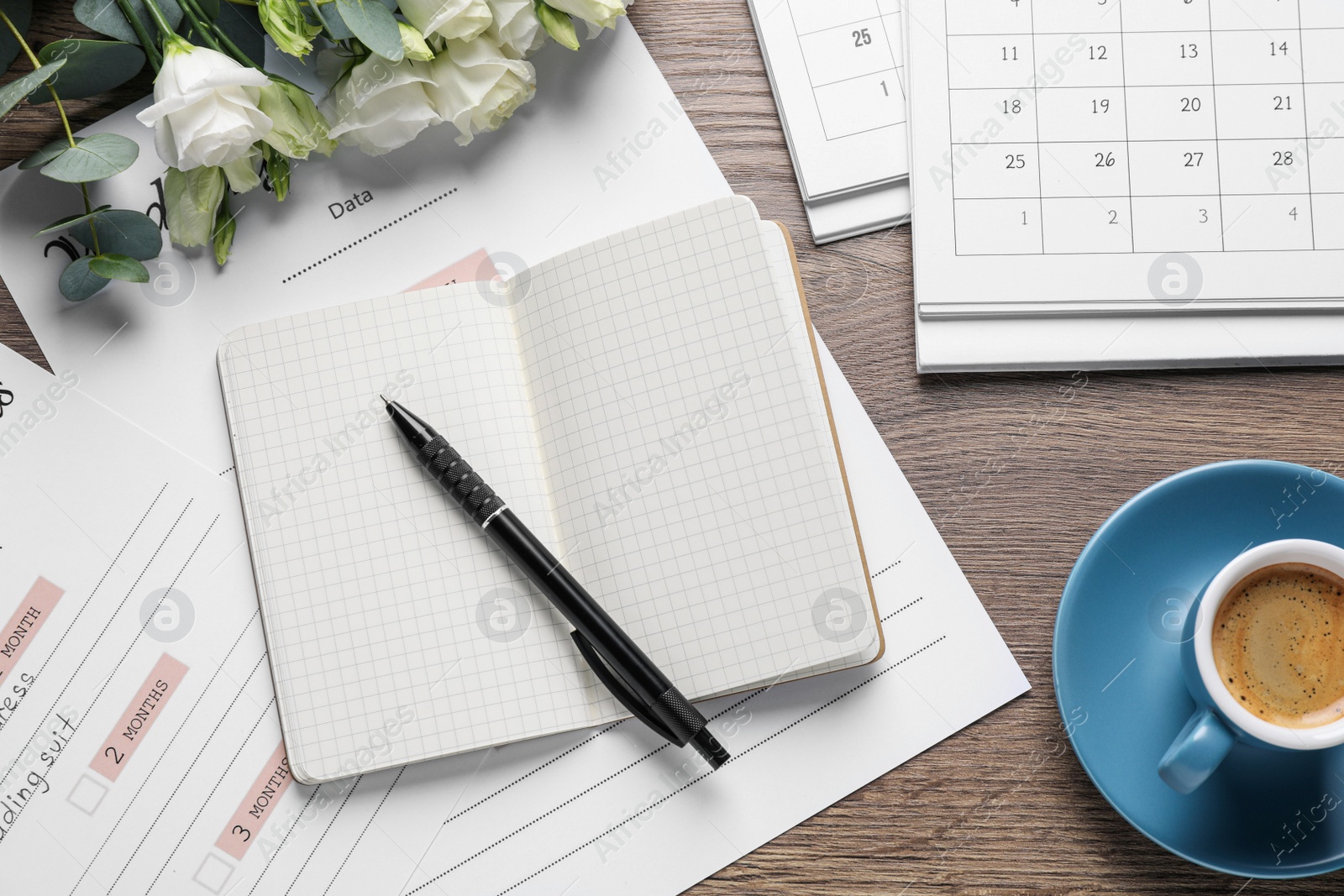 Photo of Flat lay composition with Wedding Planner on wooden table