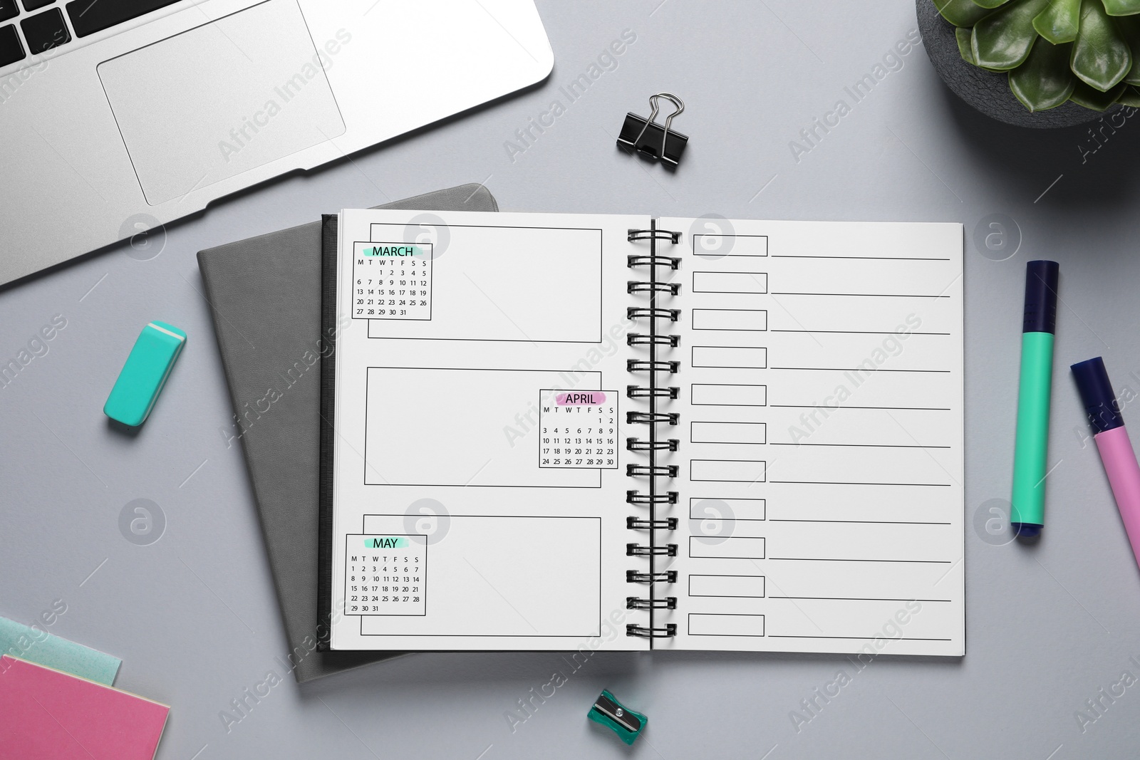 Image of Self organization with bullet journal. Notebook with calendar and empty planning lists near stationery on grey table, flat lay