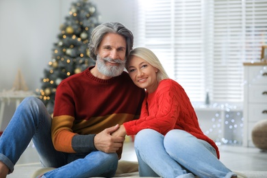 Happy mature couple celebrating Christmas at home