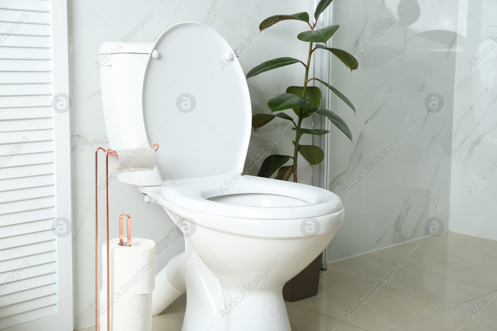 Photo of Holder with toilet paper rolls in bathroom