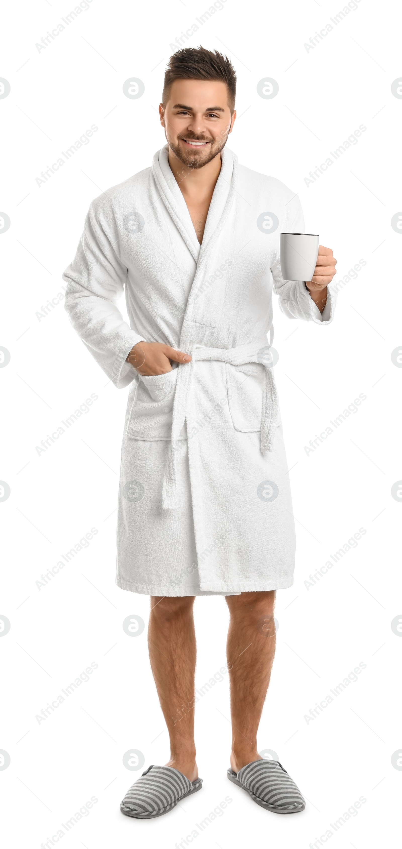 Photo of Handsome man in bathrobe with cup of coffee on white background