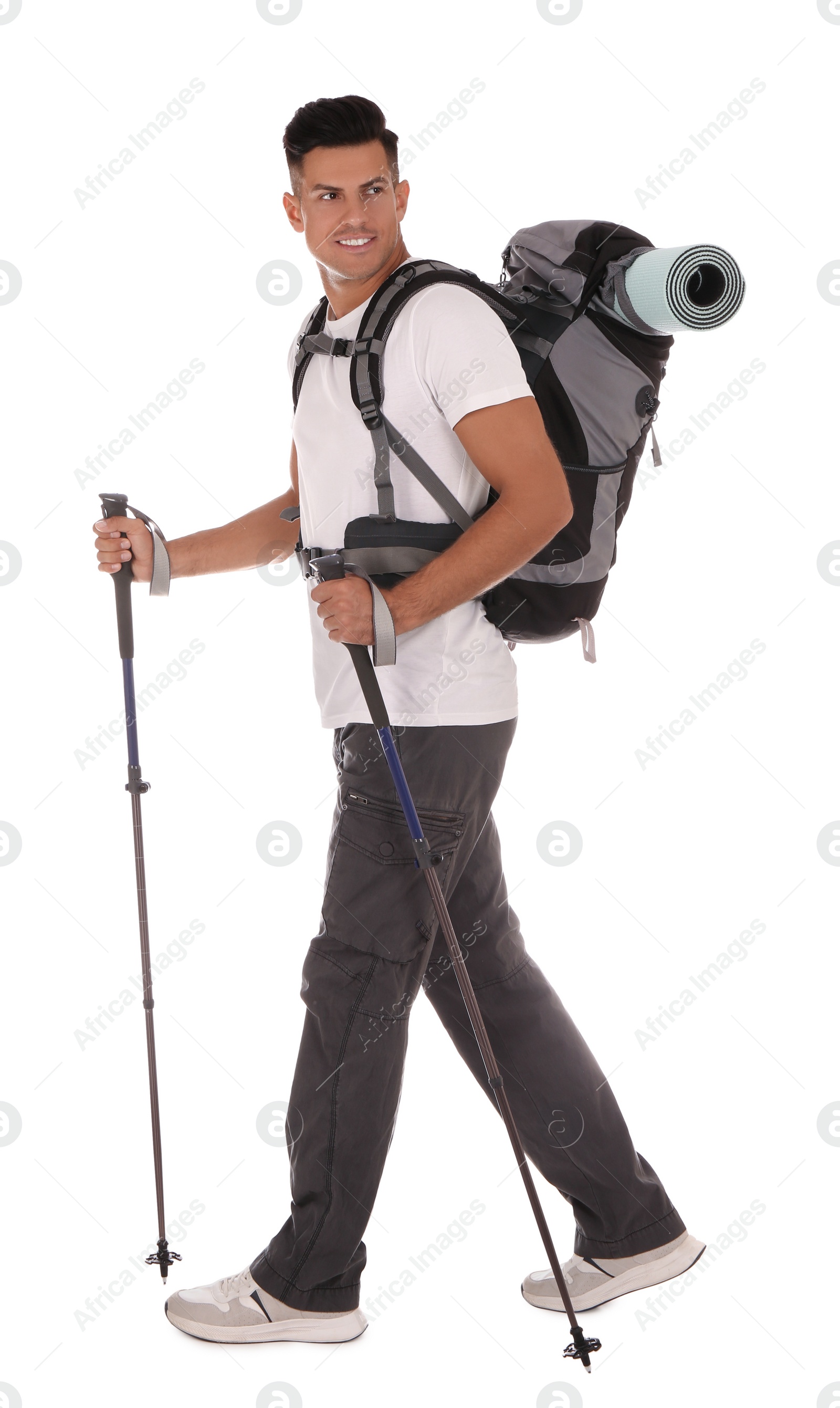 Photo of Male hiker with backpack and trekking poles on white background